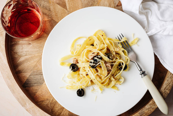 Tagliatelle pasta with tuna, olives and cheese. - Photo, Image