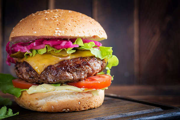 Sığır burger. Biftekli sandviç, domates, peynir, salatalık turşusu ve marul. Çizburger.. - Fotoğraf, Görsel