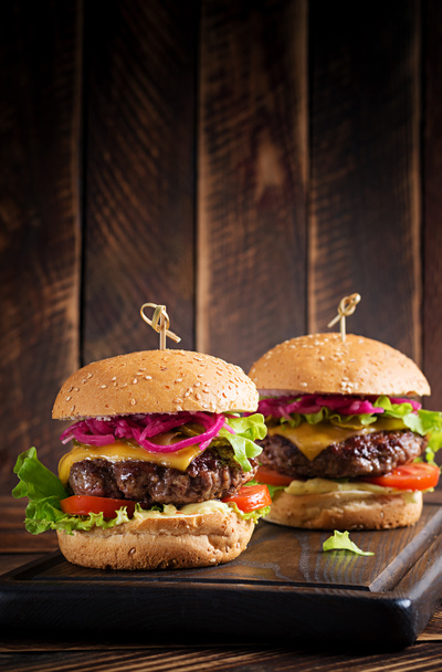Beef hamburger. Sandwich with beef burger, tomatoes, cheese, pickled cucumber and lettuce. Cheeseburger. - Photo, Image