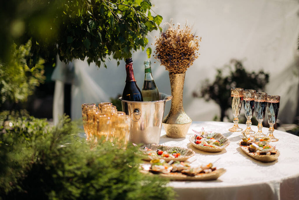Festive buffet table with champagne and appetizer on the street - Photo, Image