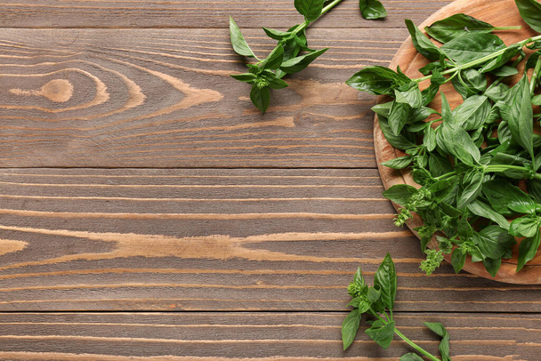 Cutting board with fresh basil on wooden background - Photo, Image