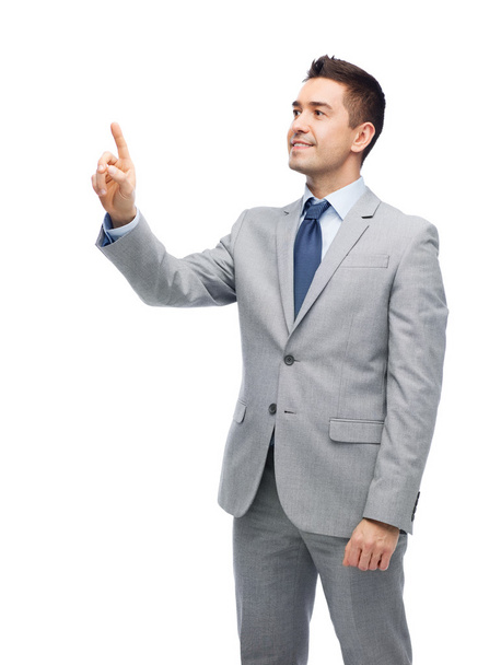 happy businessman in suit touching something - 写真・画像