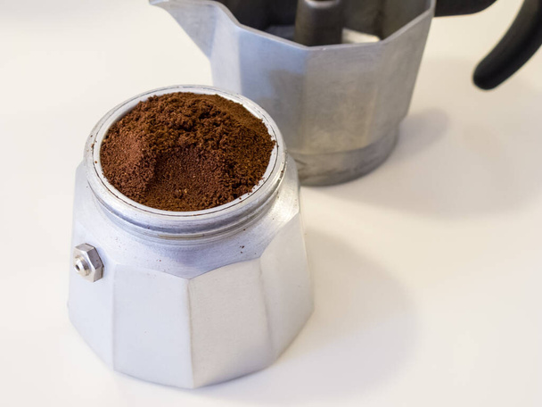 An espresso moka pot with coffee prepared for brewing. - Photo, Image