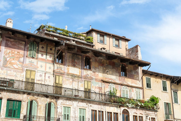 Plac z targiem stoi na starym mieście Werona, Włochy. Miasto Verona jest wpisane na listę światowego dziedzictwa UNESCO. - Zdjęcie, obraz