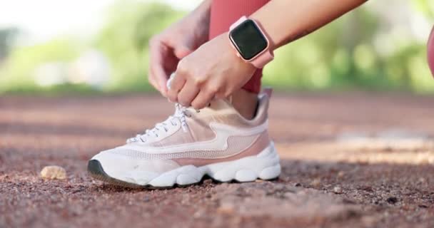 Exercise, hands and tying shoes outdoor for running, fitness and workout at a park. Feet, sneakers or lace and athlete person runner in nature to start cardio, sports or training for wellness closeup. - Felvétel, videó