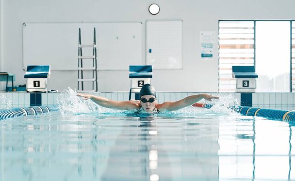 Pool, water splash and sports person swimming, training and practice challenge, fitness or workout routine in gym. Swimmer stroke, commitment and athlete cardio, race competition or match action. - Foto, imagen