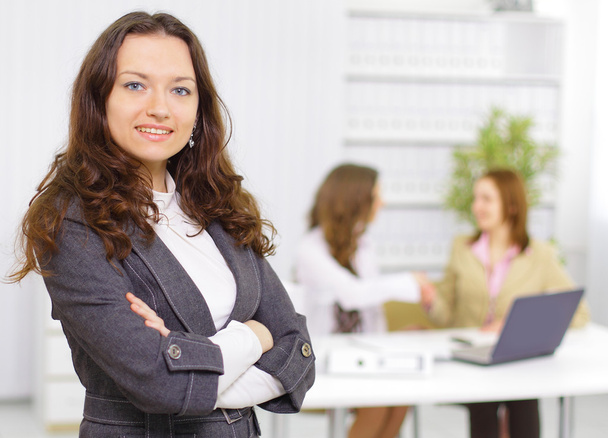 Successful business woman standing with her staff in background at office - Foto, immagini