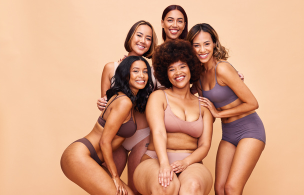 Portrait, diversity and women with beauty, cosmetics and body positivity on a beige studio background. Models, smile or group with self love, inclusion and wellness with health, aesthetic and friends. - 写真・画像