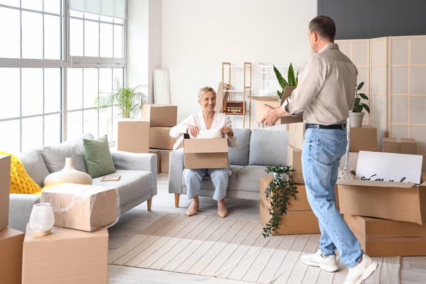 Mature couple packing things in room on moving day - Photo, Image