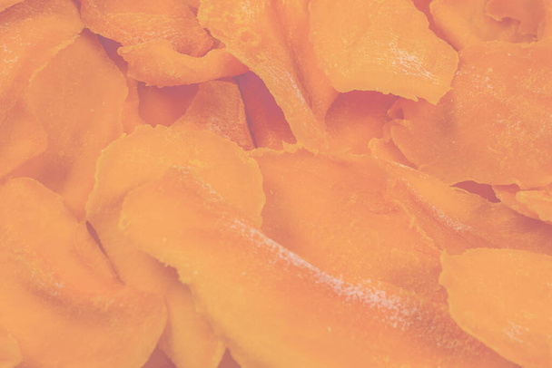 Tasty sugar mango slices background. Top view.  - Photo, Image