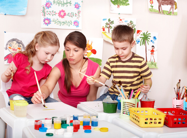 Children with teacher painting play room. - Photo, Image