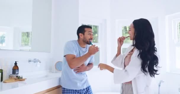 Home bathroom, brushing teeth and happy couple dance, fun and doing morning routine, tooth cleaning or dental care. Laugh, dancer and excited man, woman or marriage people grooming for oral hygiene. - Footage, Video