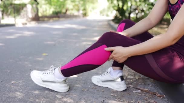 Young adult woman with muscle pain while running. A runner has a sore foot due to plantar fasciitis. Sports injury and medical concept - Footage, Video