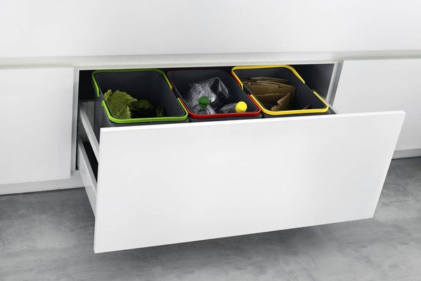 Colorful bins for sorting of plastic, paper garbage and organic waste at home. Modern kitchen with a system for sorting waste. Waste Separation Concept. Zero waste. Eco-friendly. - Photo, Image