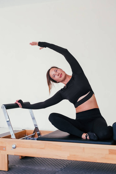 Pilates Reformer Workout Exercises Woman At Gym Indoor Stock Photo, Picture  and Royalty Free Image. Image 45807981.