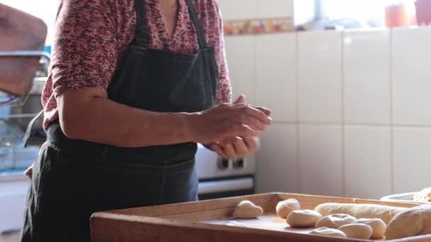 Candid Capture of Unidentified Latina Woman Crafting Dough with Hands and Rolling Pin in Rustic Home Kitchen. 4k video - Filmati, video