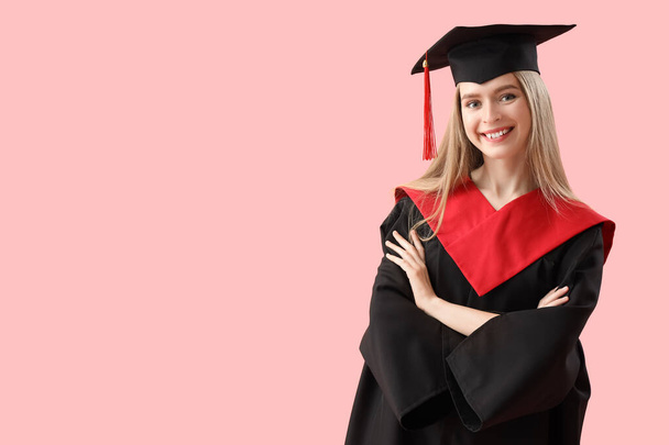 Female graduate student on pink background - Photo, Image