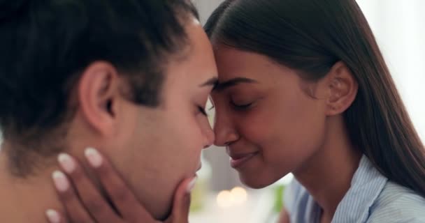 Love, intimate and young couple at their home relaxing, bonding and resting together on a weekend. Happy, smile and interracial man and woman with romance, connection and trust in their apartment - Filmagem, Vídeo