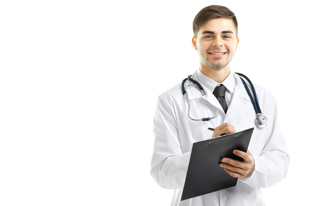 Male Doctor holding clipboard isolated on white - Zdjęcie, obraz
