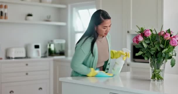 Spray, cleaning and woman at counter in kitchen for housekeeping, disinfection or safety of dust, bacteria or dirt. Sanitation, detergent or chemical bottle for cloth to wipe countertop table at home. - Footage, Video