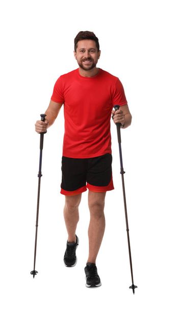 Man practicing Nordic walking with poles isolated on white - Foto, immagini