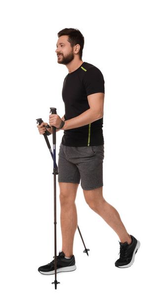 Man practicing Nordic walking with poles isolated on white - Fotó, kép