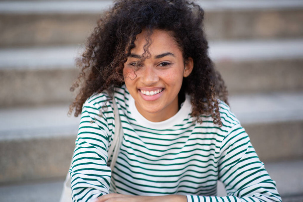 Πορτρέτο χαμογελαστή Αφροαμερικανή με σγουρά μαλλιά - Φωτογραφία, εικόνα