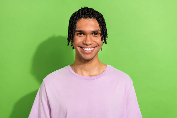 Photo of cheery cool young age guy stylish cornrows toothy smiling on camera isolated over green color background. - Zdjęcie, obraz