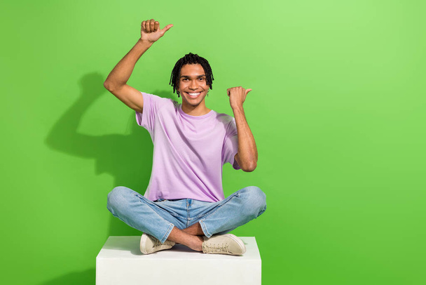 Photo of charming cool guy wear pink t-shirt showing two thumbs empty space isolated green color background. - Fotó, kép