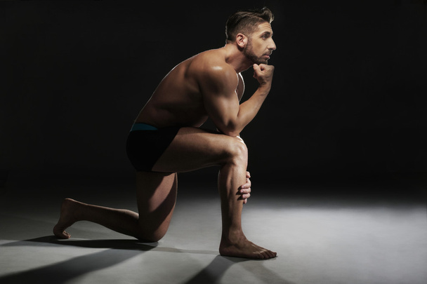 Hombre muscular en topless sentado en una posición de yoga
 - Foto, imagen