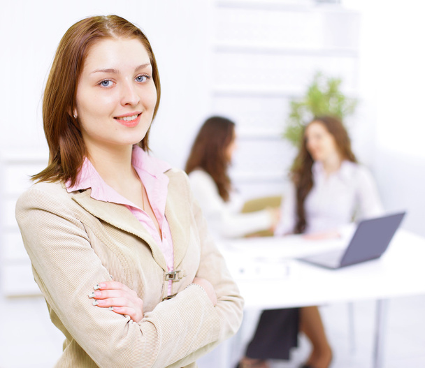 Successful business woman standing with her staff in background at office - Foto, Bild