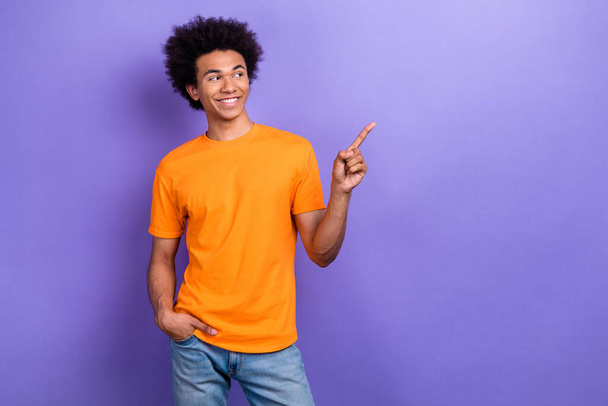 Photo of funky cheerful man toothy smile look direct finger empty space news ad isolated on violet color background. - Photo, Image