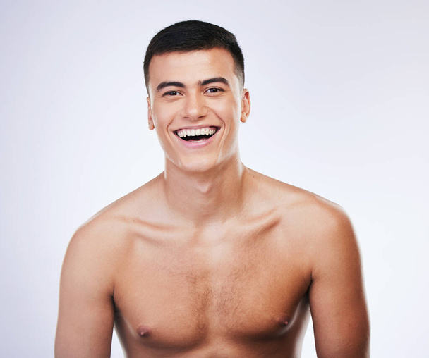 Happy man, portrait and skincare with facial and beauty treatment for skin glow and wellness in studio. Male model smile, dermatology and cosmetics for relax face with white background and confidence. - 写真・画像