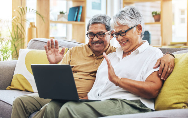 Senior couple, video call and laptop in home with voip communication, digital chat and talk. Happy man, woman and wave hello on computer in virtual conversation, online contact and retirement on sofa. - Photo, Image