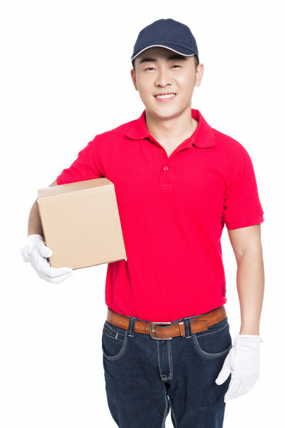 delivery man carrying cardboard box - Fotó, kép