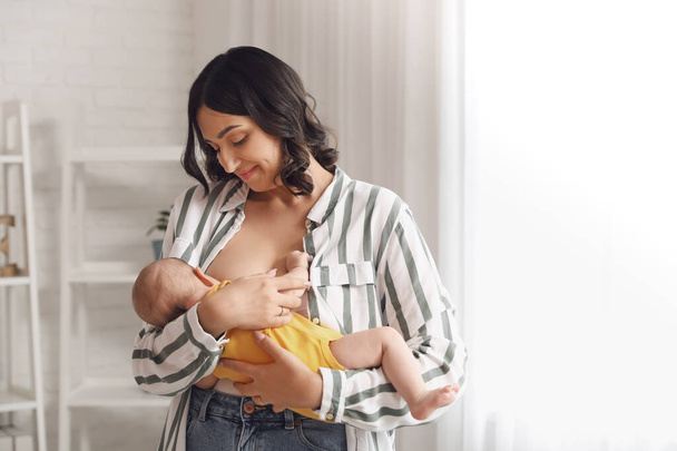 Young woman breastfeeding her baby at home - Photo, Image