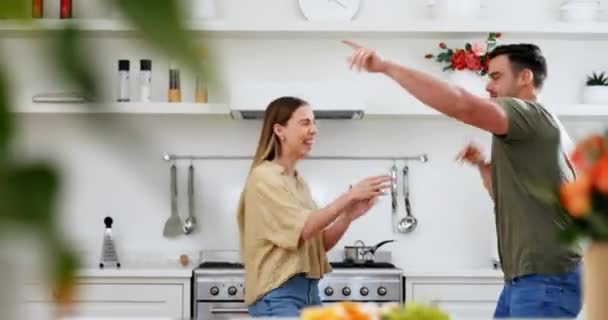 Excited, kitchen and happy couple dance to music, disco song or radio sound for crazy fun, bond and silly date. Energy, dancer and home apartment woman, man or marriage people celebrate anniversary. - Footage, Video