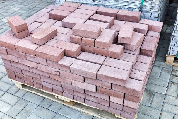 concrete paving stones stacked on pallets in outside warehouse - Photo, Image