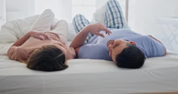 Relax, bed and couple with marriage, care and happiness with romance, commitment and smile on a weekend break. Bedroom, man and woman with relationship, home and conversation with trust and speaking. - Footage, Video