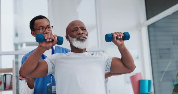 Senior care, support and physiotherapist with black man, weights and healthcare rehabilitation gym. Physio, fitness coach and or caregiver with elderly patient in mobility training clinic in Africa - Footage, Video