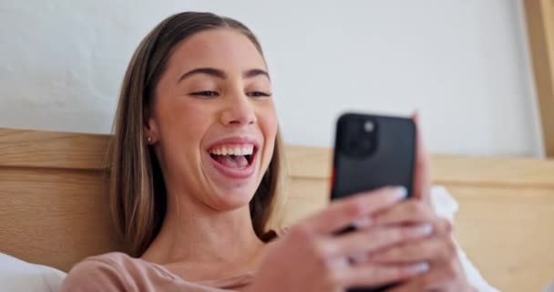 Woman, phone and texting with laugh in bed, comic meme and post on web blog in morning on vacation. Girl, smartphone and bedroom to watch funny video, movie or reading notification on social network. - Footage, Video