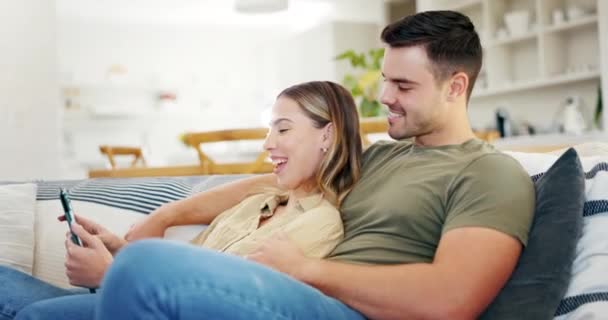 Tablet, happy and couple talking on sofa in living room for online shopping, streaming internet show or movies. Man, woman or scroll on digital tech, social media or download subscription app at home. - Footage, Video