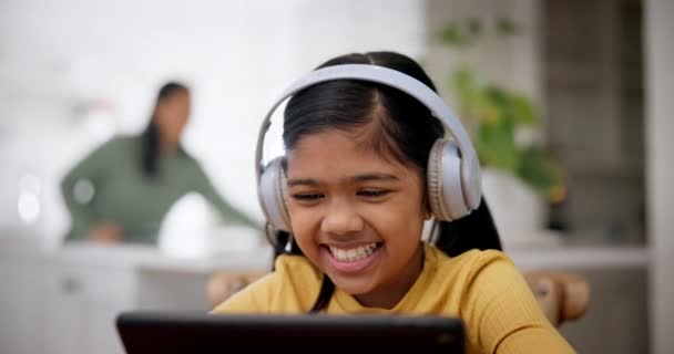Computer, child and laughing with headphones on online education, music or learning at home. Web class, smile or young girl with audio and happy from student streaming a kids video for study in house. - Footage, Video