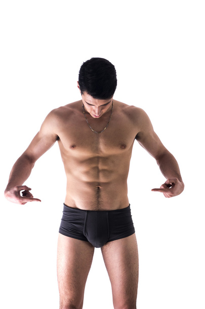 Young man in underwear pointing fingers at empty blank space for copy - Photo, Image