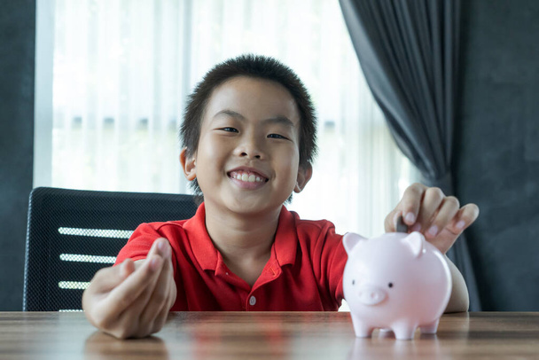 boy save money in piggy bank - Photo, Image
