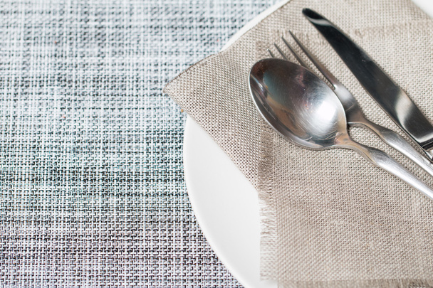 Empty white plate spoon, fork, knife  - Photo, image
