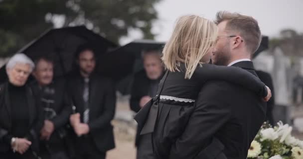 Sad, hug and a father and child at a funeral with depression and mourning at the graveyard. Holding, young and a dad with care and love for a girl kid at a cemetery burial and grieving together. - Footage, Video