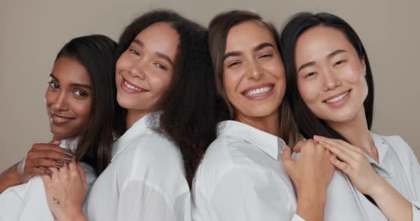 Women, face and skincare, group diversity with love, support and happy friends in portrait for cosmetics on a studio background. Young people smile together and hug for dermatology, beauty and makeup. - Footage, Video