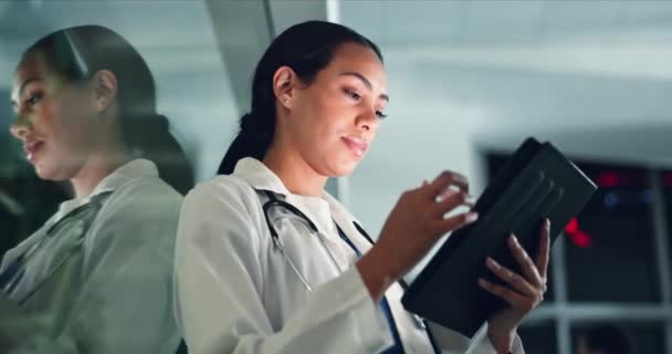 Doctor, woman and tablet at night with medical, healthcare and clinic data for research. Female professional, employee and telehealth with online consulting on a web app for wellness and planning. - Footage, Video