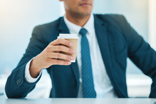 Χέρι, καφές και ένας επιχειρηματίας στο γραφείο του για πρωινό καφεΐνη σε ένα φλιτζάνι για να ξεκινήσει την ημέρα εργασίας του. Εταιρικό, ποτό και ποτό με επαγγελματία υπάλληλο σε γραφείο στο χώρο εργασίας. - Φωτογραφία, εικόνα